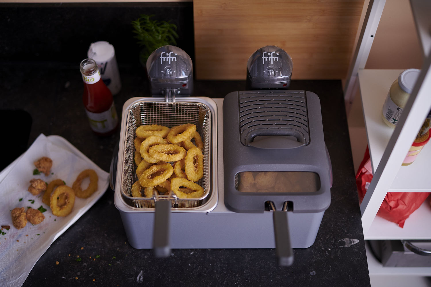 Friteuse double avec beignets d'oignon et bouchées frites.
