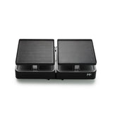 Zwarte dubbele elektrische Raclette Gourmet-grill met twee onafhankelijke kookoppervlakken — één geribbeld, het andere glad — en een PFAS-vrije keramische coating voor gezondere maaltijden, getoond tegen een witte achtergrond.