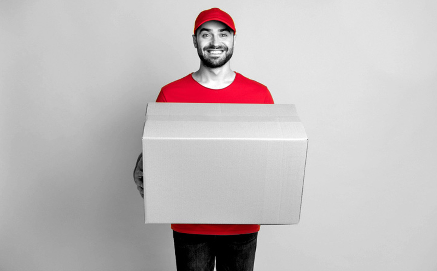cheerful guy courier dressed red clothes delivering large brown box